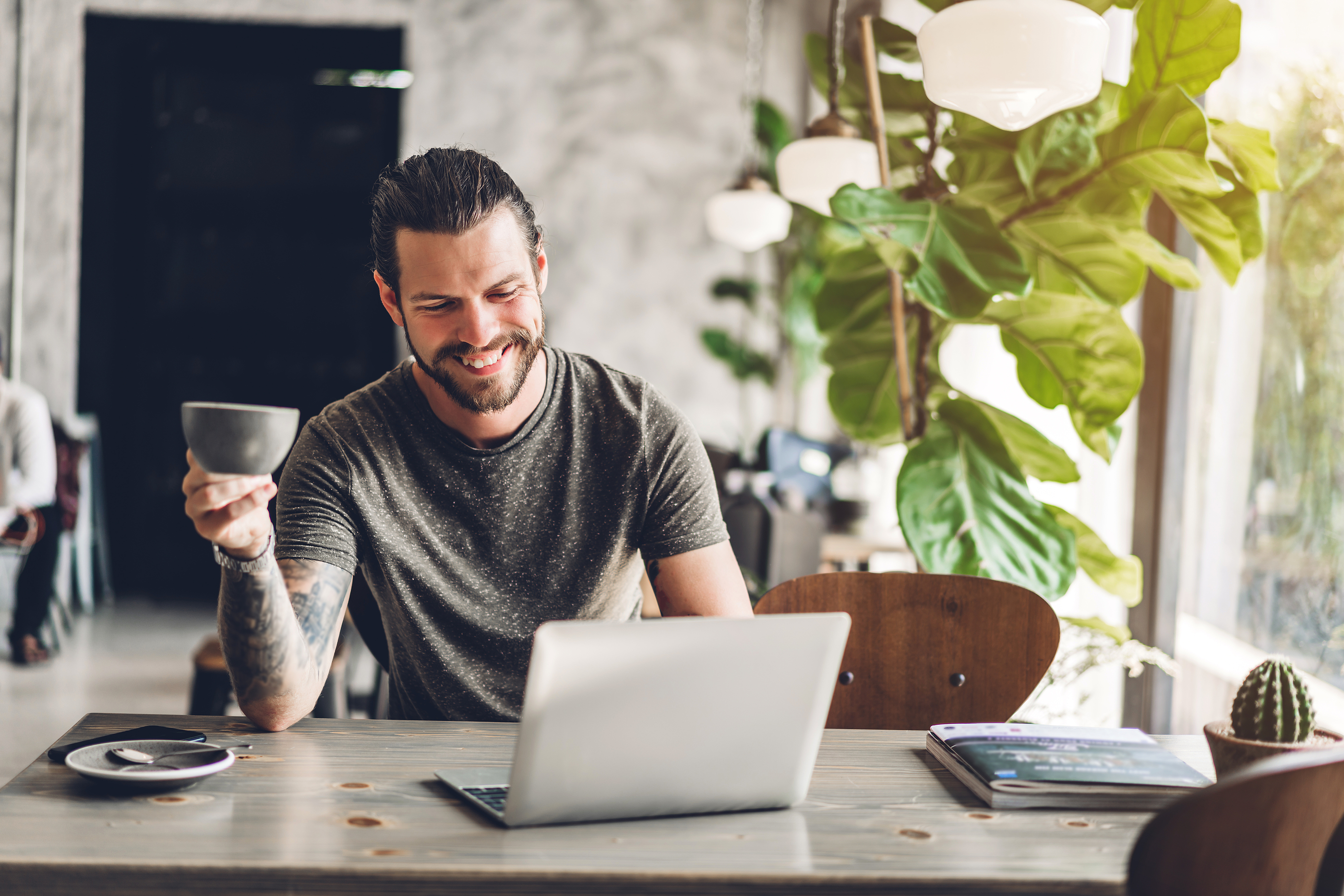 Handsome Bearded Hipster Man Use And Looking At Laptop Computer